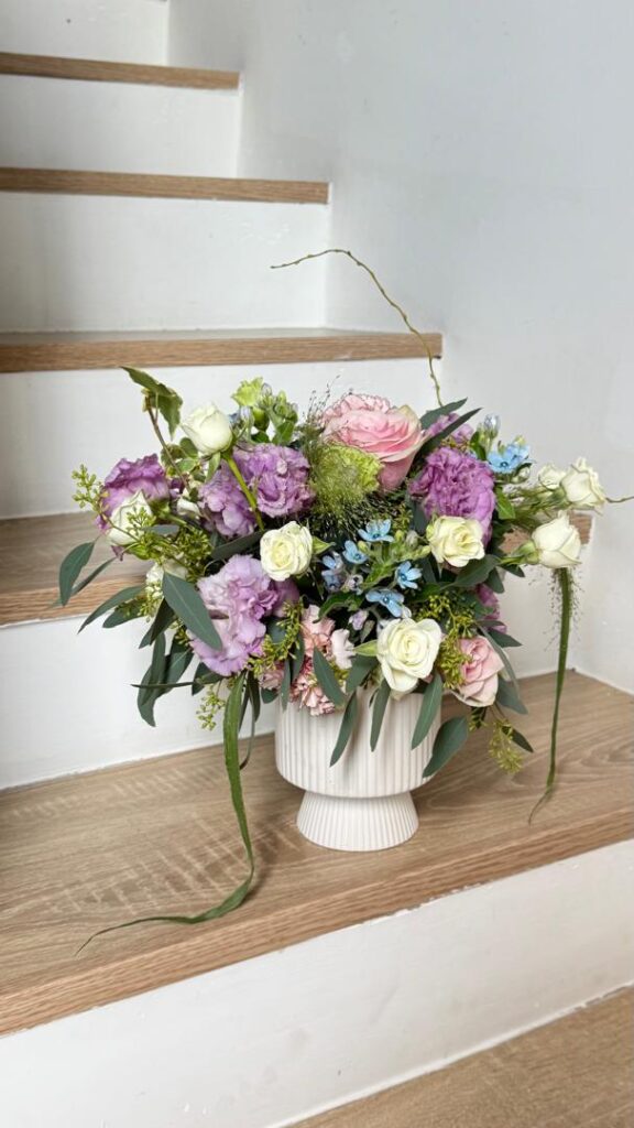 a beautiful floral basket placed at the stairacse